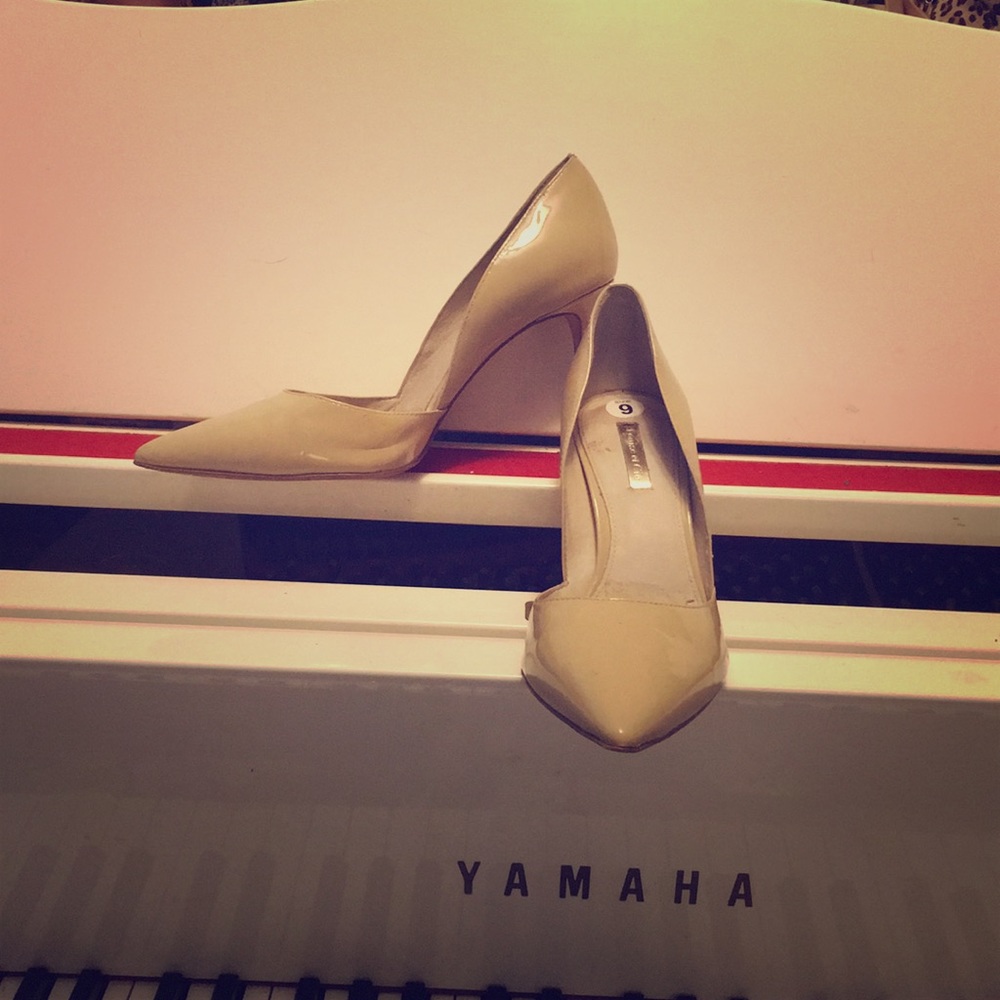 Tan patent leather heels.